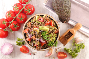 bowl of lentils salad with tomato, onion and avocado