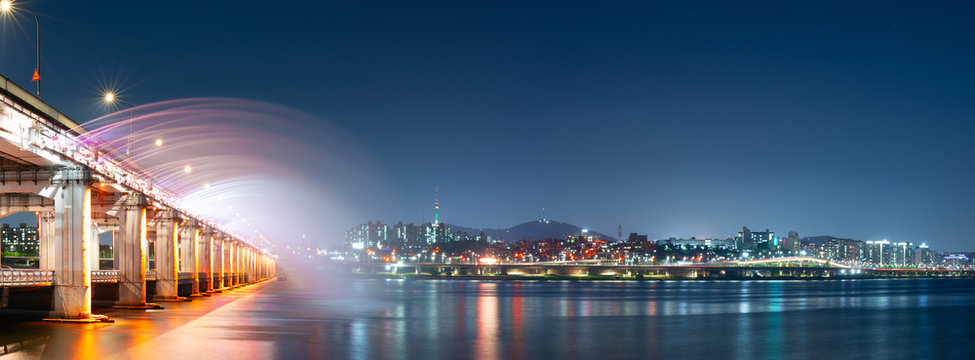 night and city scape travel and photography activity from panorama view of banpo bridge is beautiful  architecture and design during show fountain moving to people and traveler with reflect in river 