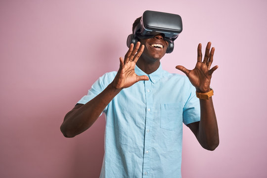 Young african american man playing virtual reality game using goggles