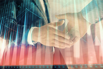 Double exposure of financial graph on cityscape background with two businessman handshake. Concept of stock market deal