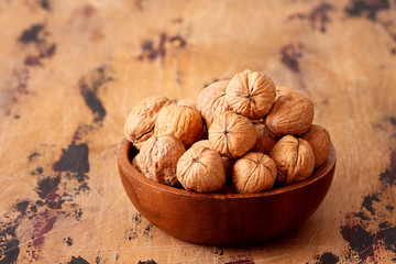 Whole walnuts in on wooden background