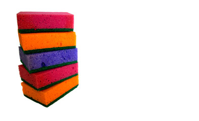 Multi-colored cleaning sponges for washing dishes on a white background isolated. Pile of dish sponges copy space.