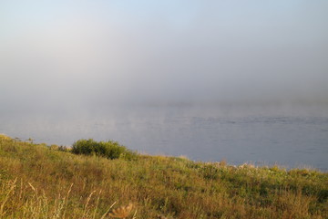 riverbank on a foggy summer morning