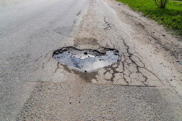 Heart shaped pit on road asphalt