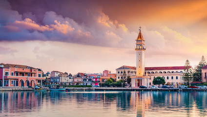 Impressive spring sunset in Zakynthos city. Dramatic evening view of the town hall and Saint Dionysios Church, Ionian Sea, Zakynthos island, Greece, Europe. Traveling concept background.
