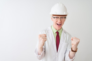 Albino scientist man wearing glasses and helmet standing over isolated white background celebrating surprised and amazed for success with arms raised and open eyes. Winner concept.