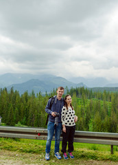 Fototapeta na wymiar Tourists couple in the mountains