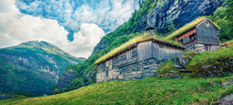 Norwegian typical grass roof wooden old house near Seven Sister waterfall. Colorful summer panorama of Norway, Europe. Beauty of countryside concept background. Instagram filter toned.