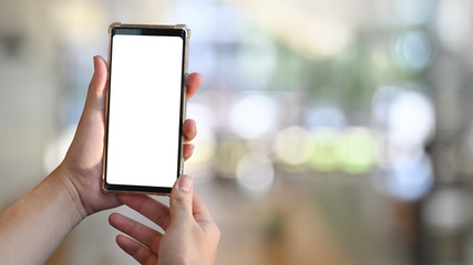 Closeup hands holding smartphone with montage isolated screen.