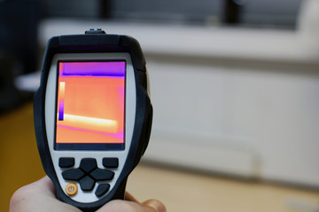 Thermal imaging camera, checking heat leaks at the house. Copy space.
