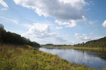 River banks and sky with cumulus clouds
