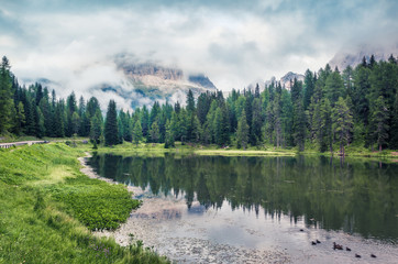 Beautiful summer scene of Antorno lake with Tre Cime di Lavaredo (Drei Zinnen) mount in the morning mist. Misty morning view of Dolomite Alps, Italy, Europe. Beauty of nature concept background.