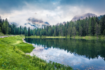 Misty summer scene of Antorno lake with Tre Cime di Lavaredo (Drei Zinnen) mount in the morning mist. Misty autumn view of Dolomite Alps, Italy, Europe. Orton Effect.