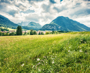 Green summer view of Triglav mountain range and  Gozd Martuljek village. Colorful morning scene of Julian Alps, Slovenia, Europe. Traveling concept background. Orton Effect.