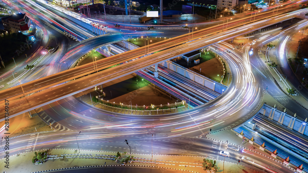 Wall mural aerial view expressway motorway highway circus intersection at night time top view , road traffic in