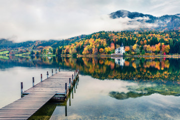 Foggy autumn view of Grundlsee lake. Cololrful morning scene of Brauhof village, Styria stare of Austria, Europe. Colorful view of Alps. Traveling concept background. Orton Effect..