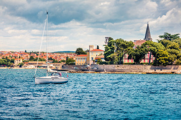 Sunny morning cityscape of popular summer resort Porec. Bright spring seascape of Adriatic Sea. Bright  scene of Istrian Peninsula in western Croatia, Europe. Traveling concept background.