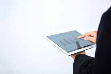 Closeup shot of an unrecognisable businesswoman analysing graphs on a digital tablet in an office