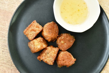 deep fried crab roll dumpling dipping sweet sauce on dish