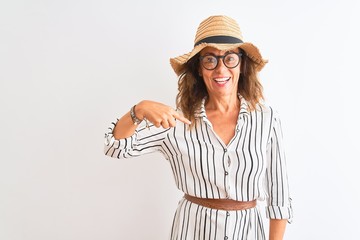 Obraz na płótnie Canvas Middle age businesswoman wearing striped dress glasses hat over isolated white background with surprise face pointing finger to himself
