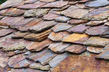 Detail view of a stone roof made of stone shingles.