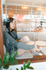 woman Look out of window city reflect