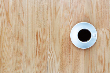 Cup of coffee on a wood table with copy space