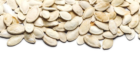 Heap of pumpkin salty seeds isolated on white