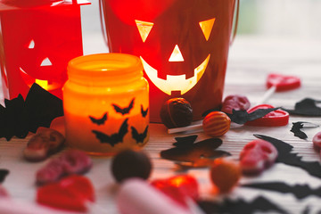 Halloween jack o lantern bucket, glowing candle, festive candy, skulls, black bats, ghost, spider...