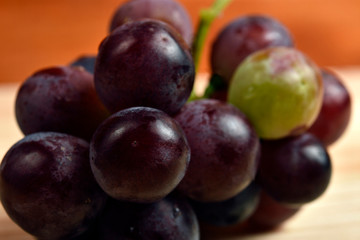 Freshly purchased grapes, placed in wood and with a diffuse background