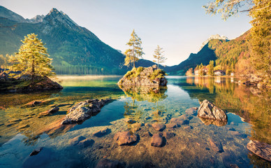 Incredible autumn scene of Hintersee lake. Sunny morning view of Bavarian Alps on the Austrian...