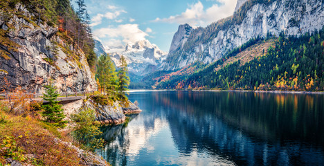 Colorful autumn panorama of Vorderer ( Gosausee ) lake with Dachstein glacier on background....