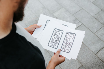 Naklejka premium UX mobile application wireframe. Sketch, prototype, framework, layout future app design project. UI/UX - user interface and user experience designer. Creative concept for smartphone. App development