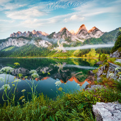 Dreamy summer view of Grosser Donnerkogel mountain range, Austria, Europe. Colorful morning scene of Vorderer (Gosausee) lake in Austrian Alps. Beauty of nature concept background.