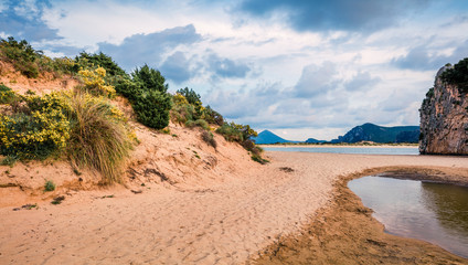 Bright spring view of Voidokilia beach. Colorful sunset on the Ionian Sea, Pilos town location, Greece, Europe. Beauty of nature concept background. Artistic style post processed photo.