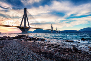 Dramatic evening scene with Rion-Antirion Bridge. Colorful spring scene of the Gulf of Corinth,...