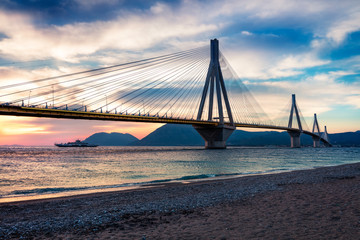 Dramatic evening scene with Rion-Antirion Bridge. Colorful spring scene of the Gulf of Corinth,...
