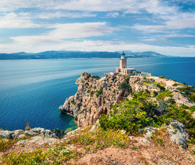Fototapeta na wymiar Bright sunny view of Melagavi lighthouse in the Corinth Gulf. Picturesque spring seascape in the Greece, Europe. Beauty of nature concept background. Artistic style post processed photo.