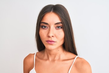 Young beautiful woman wearing casual t-shirt standing over isolated white background with a confident expression on smart face thinking serious