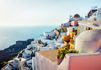 Sunny morning view of Santorini island. Bright spring scene of the famous Greek resort Oia, Greece, Europe. Traveling concept background. Artistic style post processed photo.