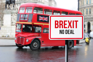 Blurred London street view with red double decker bus and Brexit no deal sign in rainy day. Possible exit of Great Britain from the EU. Brexit concept.