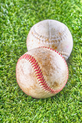 Old baseballs over synthetic grass
