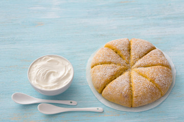 Freshly baked carrot scones with cream on light blue background. delicious homemade cakes