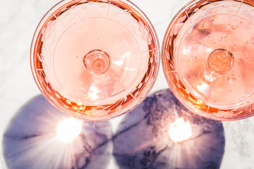 Two crystal stemmed glasses with rose wine on marble table outdoors in a cafe. Aperitif and relax time - 288749383