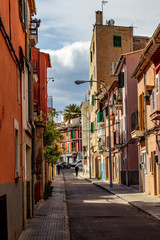 Fototapeta premium Narrow street in the old town, historic center of Palma on balearic island Mallorca, Spain on a sunny day