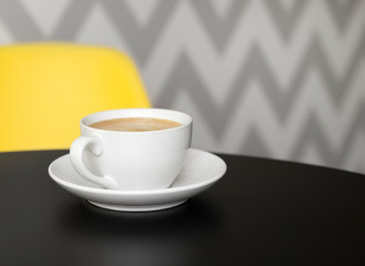 Coffee in white cup on black table at the kitchen or cafe