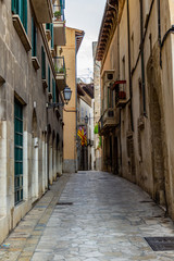 Fototapeta na wymiar Narrow street in the old town, historic center of Palma on balearic island Mallorca, Spain on a sunny day