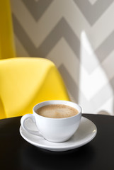 Coffee in white cup on black table at the kitchen or cafe