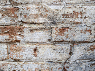 rounded Old dirty brickwork arch. White ruined whitewash. Background texture. Scratches and bumps