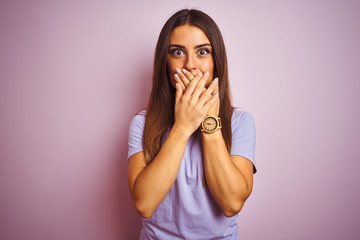 Young beautiful woman wearing casual t-shirt standing over isolated pink background shocked covering mouth with hands for mistake. Secret concept.